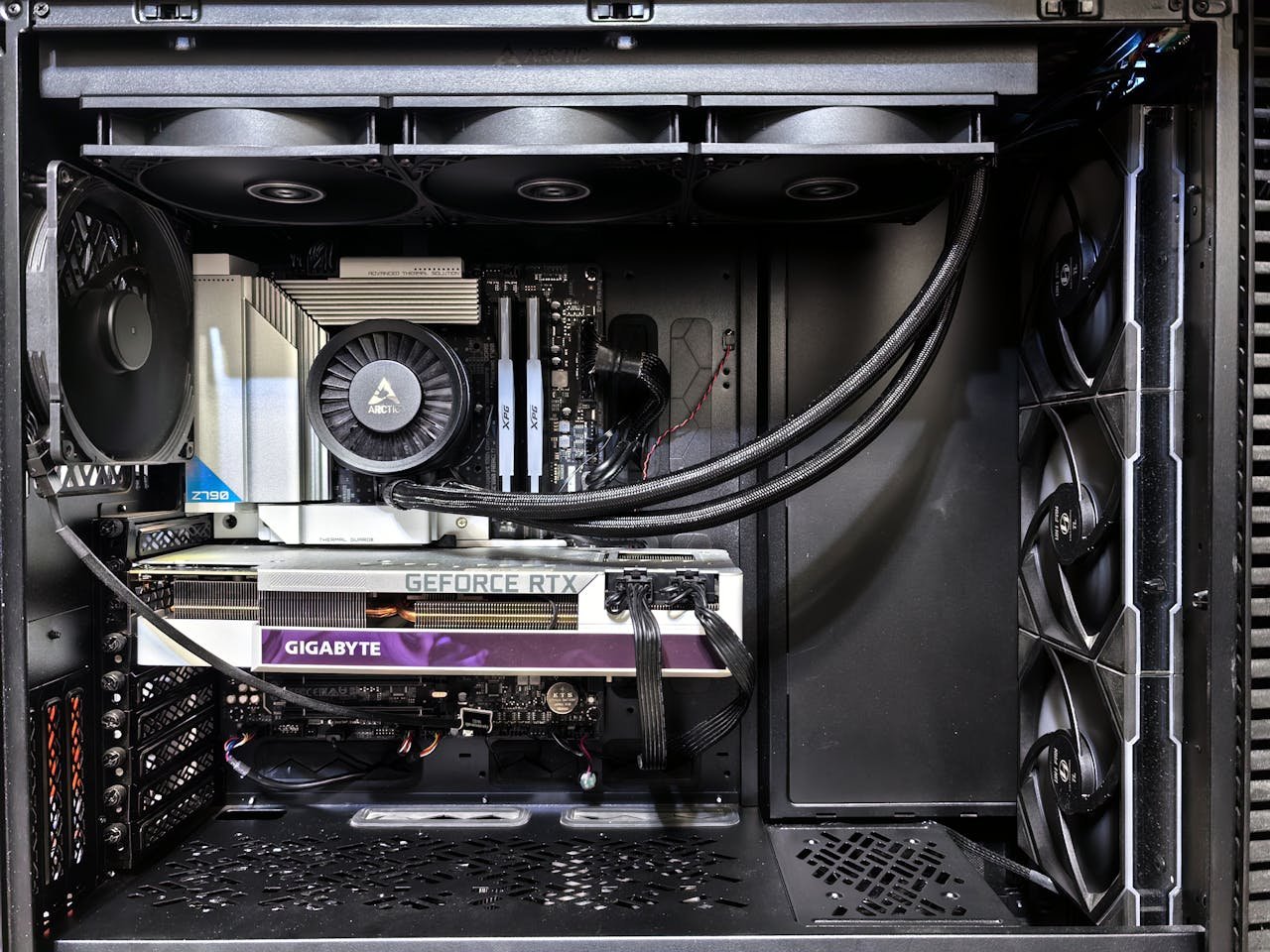 Interior view of a gaming PC showcasing a GeForce RTX graphics card and high-performance cooling system.